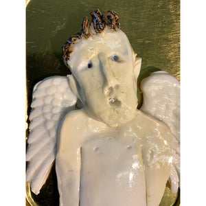 Ceramic guardian angels housed in a tobacco tin by mixed media artist Heather Tobias man