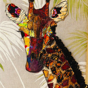 This giraffee is created usin collaged fabrics that are then stitched.