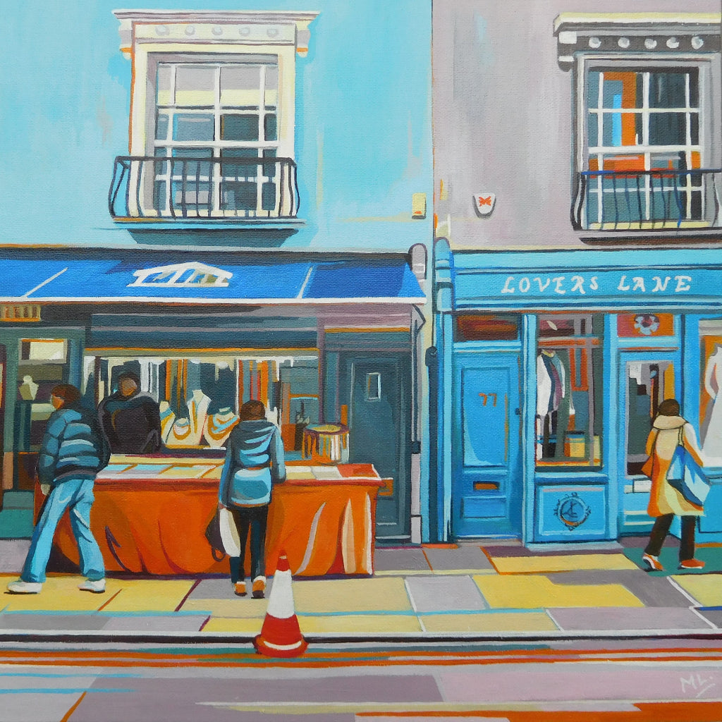 A colourful image of a street in Portobello Road London showing a blue shop front called Lovers Lane by Mary Leach artist