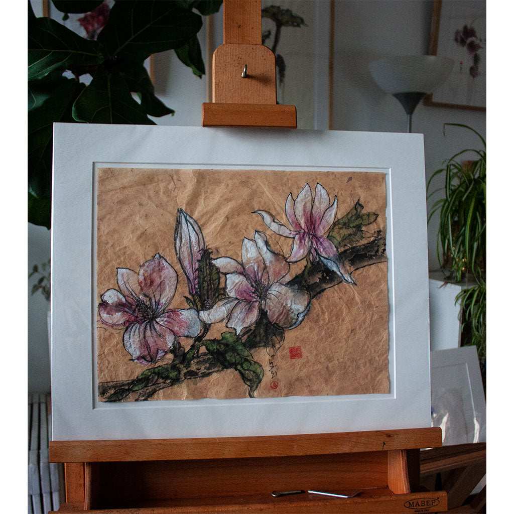 Ink painting of the magnolia, mounted, and placed on an easel in my studio