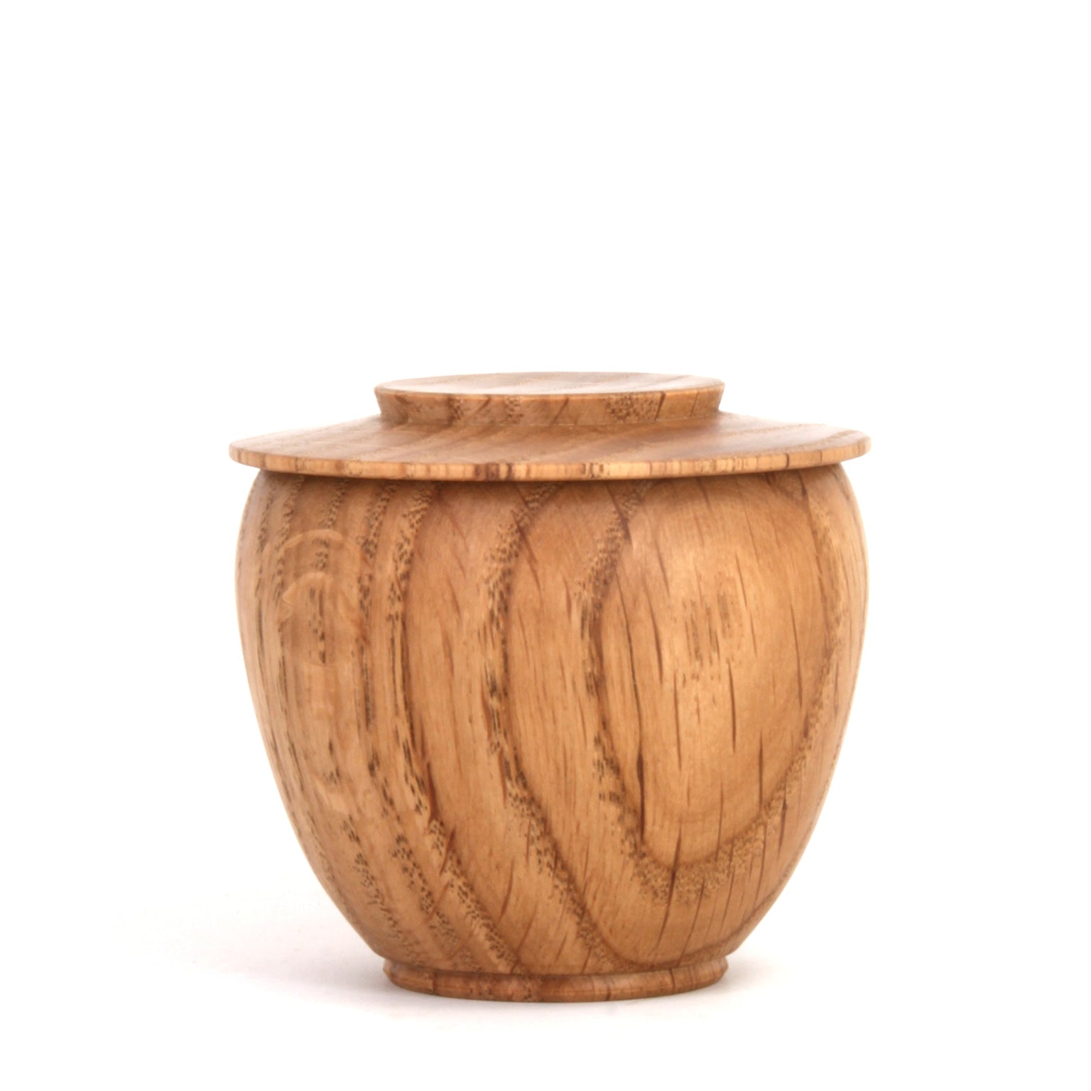 A small round wooden lidded container or jar with a natural warm brown wood grain finish, photographed on a clean white background.