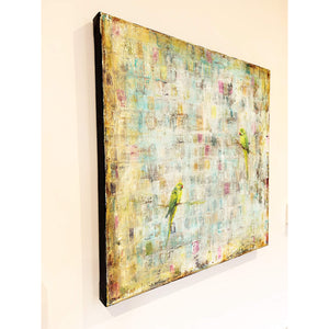 Side view on wall of abstract painting in warm hues featuring two perched green parakeets.