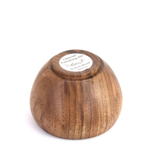 A round wooden bowl with a visible grain pattern, photographed from underneath. The bowl is set against a plain white background.