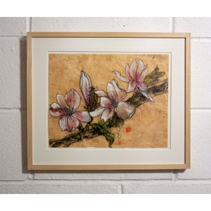 framed ink paintring of Magnolia on a white wall in the studio