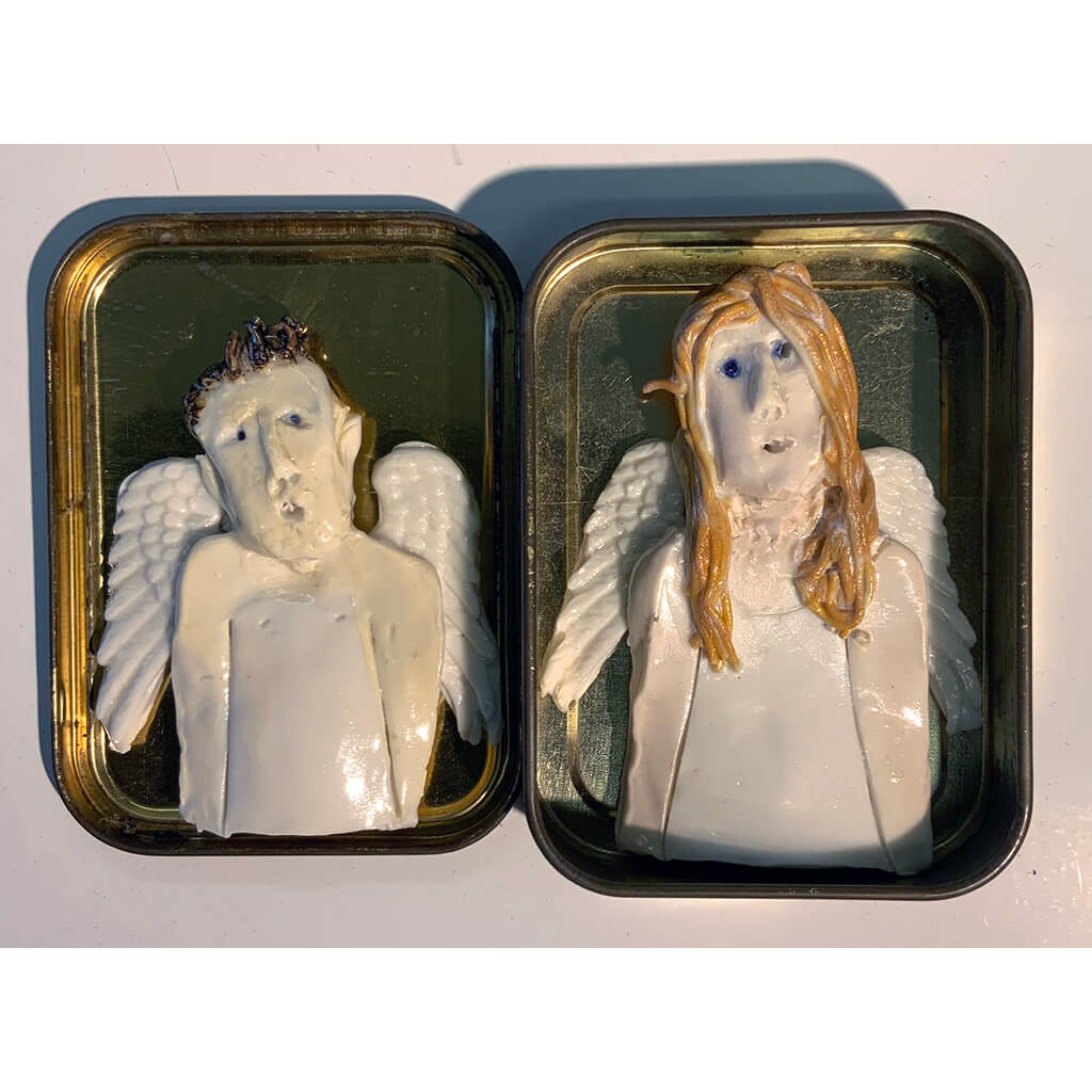 Ceramic guardian angels housed in a tobacco tin by mixed media artist Heather Tobias