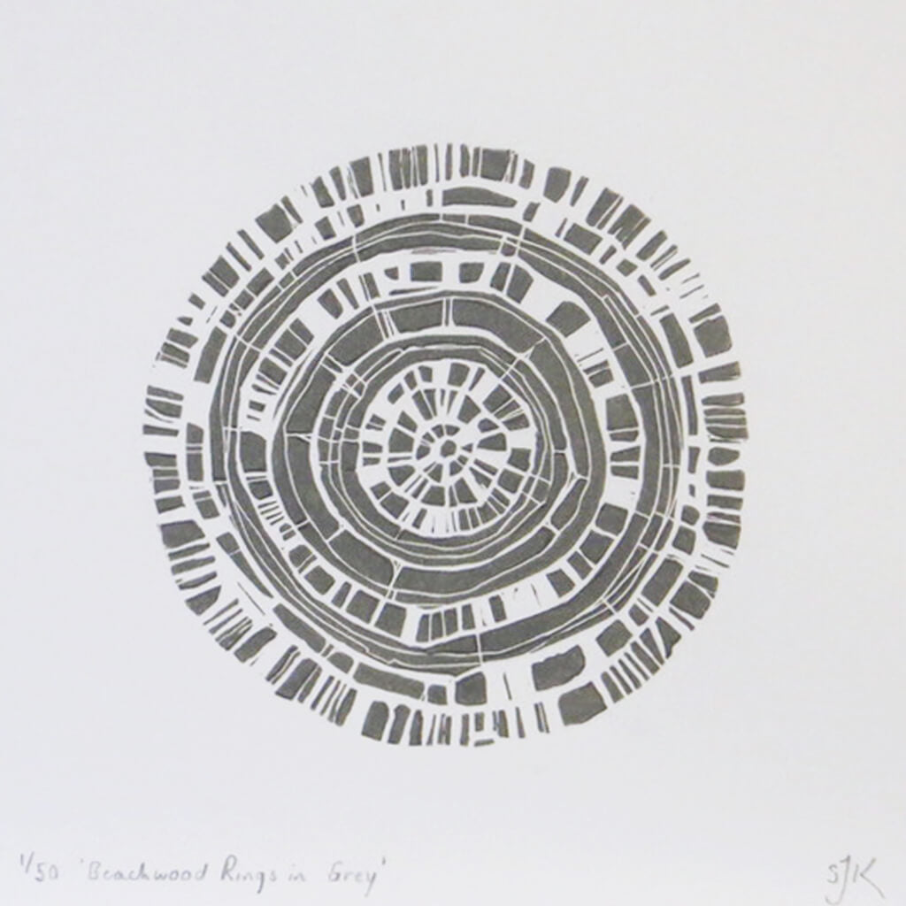 Hand printed linocut by artist Sarah Knight. Beachwood Rings is available in grey, in an optional navy blue frame.