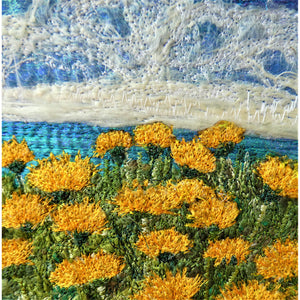 Cliff Top View by Diana Mckinnon embroidery artist comprising blue sky, ocean and yellow coastal flowers detail