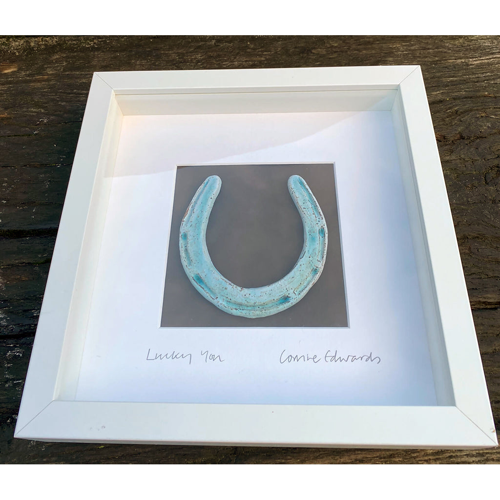 Lucky You Stoneware clay horseshoe with dry sky-blue glaze by Corrine Edwards South London ceramic artist