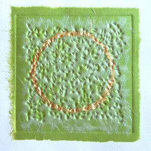abstract artwork - embossed collage by London-based textural artist gill hickman, a textured golden circle floats on a background of soft greens