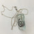 Spiral by Eryka Isaak glass pendant on sterling silver kerb chain necklace side