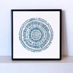 Hand printed linocut by artist Sarah Knight. Weathered Woodrings is available in either crimson or teal, both in an optional navy blue frame.
