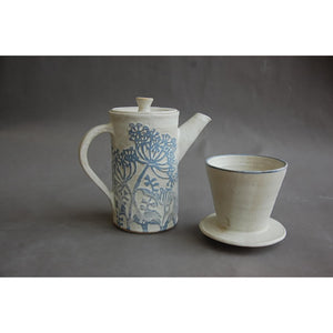 A stoneware coffee pot and filter decorated with light blue wild flowers on white by London ceramic artist Jonquil Cook