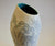 Handbuilt stoneware ceramic vase with turquoise glazed interior and exterior sgraffito decoration depicting wildflowers and grasses